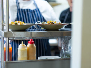 Chef prepping meal with sauces