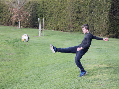Boy kicking ball
